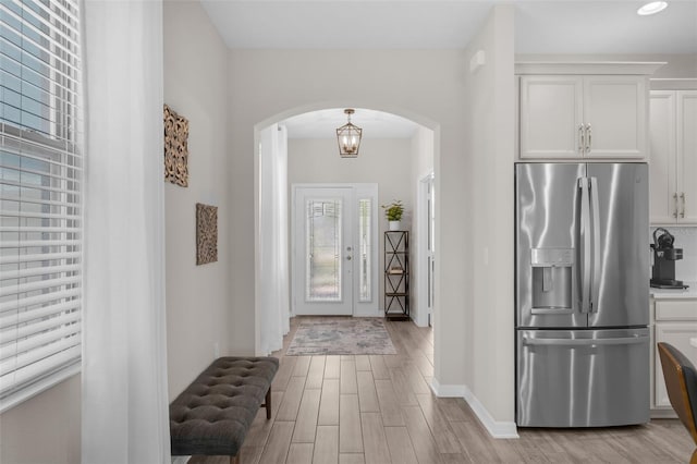 1896 Napoli Dr, Saint Cloud, FL 34771 - foyer featuring arched walkways, light wood finished floors, baseboards, and recessed lighting