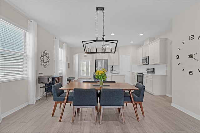 1896 Napoli Dr, Saint Cloud, FL 34771 - dining room with light wood-style floors, a chandelier, baseboards, and recessed lighting