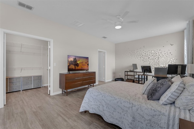 1896 Napoli Dr, Saint Cloud, FL 34771 - bedroom with wood finished floors, baseboards, a ceiling fan, a walk in closet, and an office area