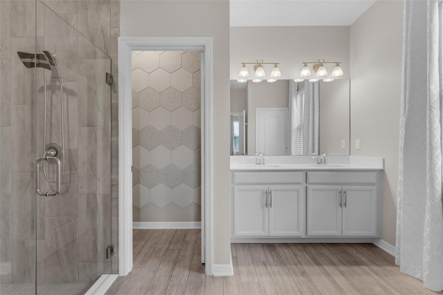 1896 Napoli Dr, Saint Cloud, FL 34771 - full bathroom featuring a shower stall, wood finished floors, double vanity, and baseboards