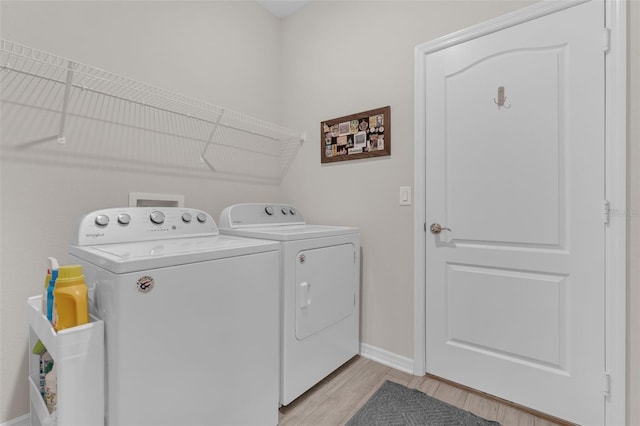 1896 Napoli Dr, Saint Cloud, FL 34771 - washroom with washer and dryer, light wood-style floors, and baseboards