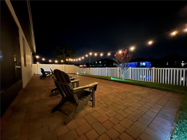 1896 Napoli Dr, Saint Cloud, FL 34771 - patio at night with a patio and a fenced backyard