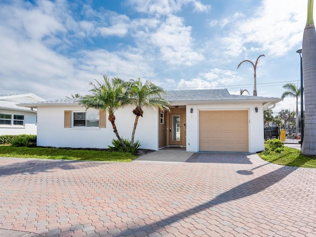 6300 Midnight Pass Rd Unit 5, Sarasota, FL 34242 - ranch-style house with decorative driveway, a garage, and stucco siding
