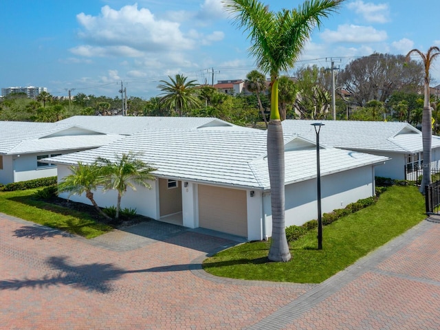 6300 Midnight Pass Rd Unit 5, Sarasota, FL 34242 - ranch-style house with stucco siding, a garage, decorative driveway, and a front lawn