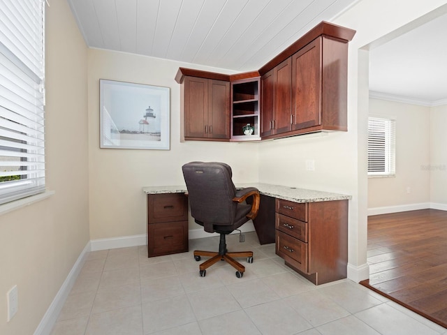 6300 Midnight Pass Rd Unit 5, Sarasota, FL 34242 - home office with built in study area, plenty of natural light, ornamental molding, baseboards, and light tile patterned flooring
