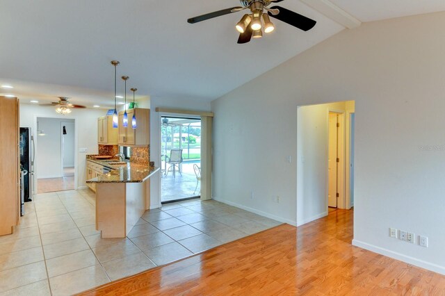 8402 13th Ave NW, Bradenton, FL 34209 - kitchen featuring ceiling fan, freestanding refrigerator, dark stone countertops, tasteful backsplash, and a sink