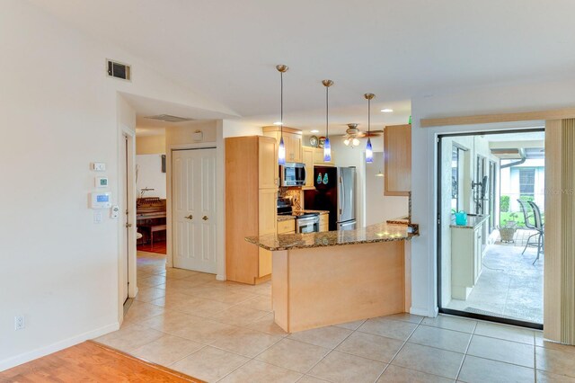 8402 13th Ave NW, Bradenton, FL 34209 - kitchen with stainless steel appliances, stone countertops, ceiling fan, a peninsula, and light tile patterned flooring