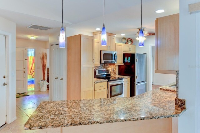 8402 13th Ave NW, Bradenton, FL 34209 - kitchen featuring stainless steel appliances, light tile patterned flooring, tasteful backsplash, light stone countertops, and light brown cabinetry