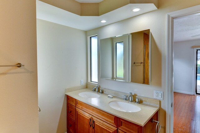8402 13th Ave NW, Bradenton, FL 34209 - full bath with double vanity, recessed lighting, and wood finished floors
