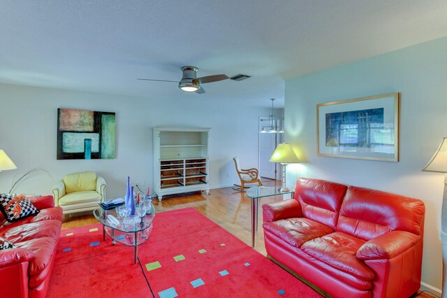 8402 13th Ave NW, Bradenton, FL 34209 - living room with wood finished floors, a ceiling fan, and baseboards