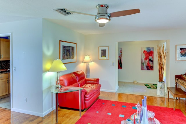 8402 13th Ave NW, Bradenton, FL 34209 - living area with a ceiling fan, light wood-style floors, and baseboards