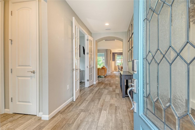 11502 Golden Bay Pl, Bradenton, FL 34211 - foyer entrance featuring arched walkways, light wood-type flooring, baseboards, french doors, and recessed lighting