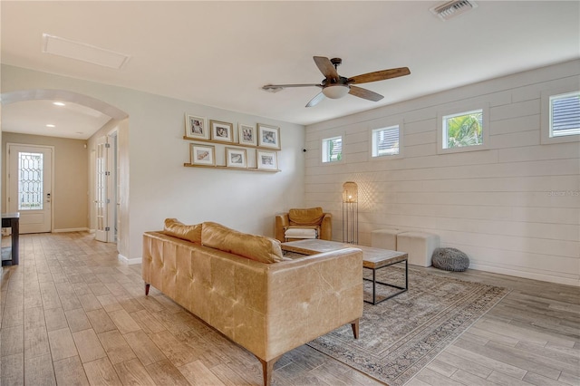 11502 Golden Bay Pl, Bradenton, FL 34211 - living area with arched walkways, light wood-style floors, a ceiling fan, and baseboards