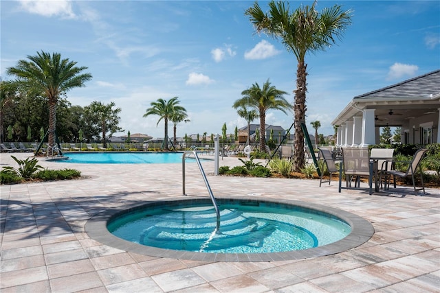 11502 Golden Bay Pl, Bradenton, FL 34211 - community pool featuring a patio, a hot tub, outdoor dining space, and a ceiling fan