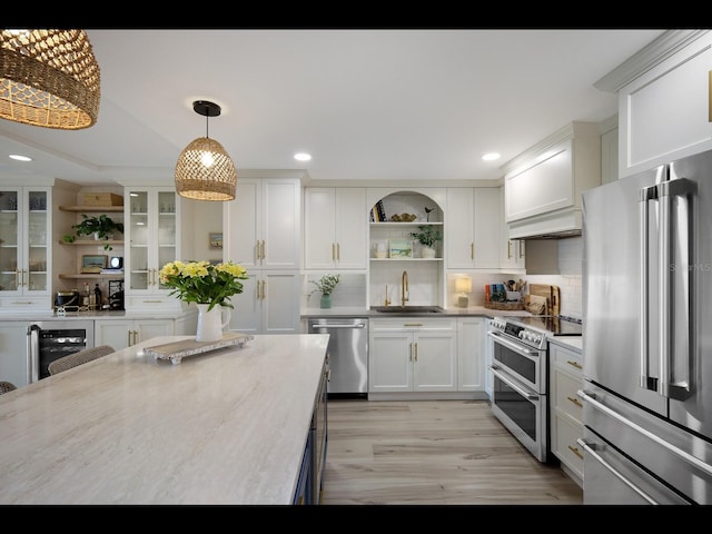 2045 Gulf Of Mexico Dr Unit M1-505, Longboat Key, FL 34228 - kitchen with appliances with stainless steel finishes, open shelves, a sink, white cabinetry, and decorative backsplash