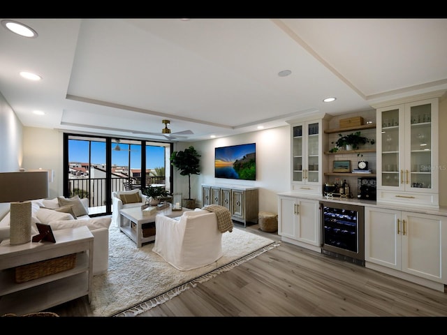 2045 Gulf Of Mexico Dr Unit M1-505, Longboat Key, FL 34228 - living area featuring beverage cooler, wet bar, light wood-style flooring, a tray ceiling, and recessed lighting