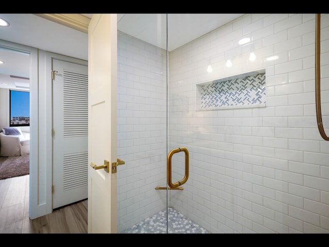 2045 Gulf Of Mexico Dr Unit M1-505, Longboat Key, FL 34228 - bathroom with wood finished floors, a shower stall, and recessed lighting