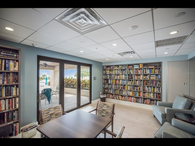 2045 Gulf Of Mexico Dr Unit M1-505, Longboat Key, FL 34228 - office area featuring wall of books, a drop ceiling, wood finished floors, and recessed lighting