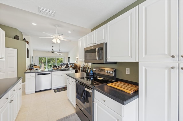 7532 Marsh Orchid Cir Unit 8-201, Bradenton, FL 34203 - kitchen featuring appliances with stainless steel finishes, dark countertops, white cabinetry, and recessed lighting