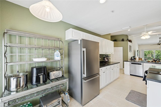 7532 Marsh Orchid Cir Unit 8-201, Bradenton, FL 34203 - kitchen with appliances with stainless steel finishes, dark countertops, a ceiling fan, white cabinets, and light tile patterned flooring