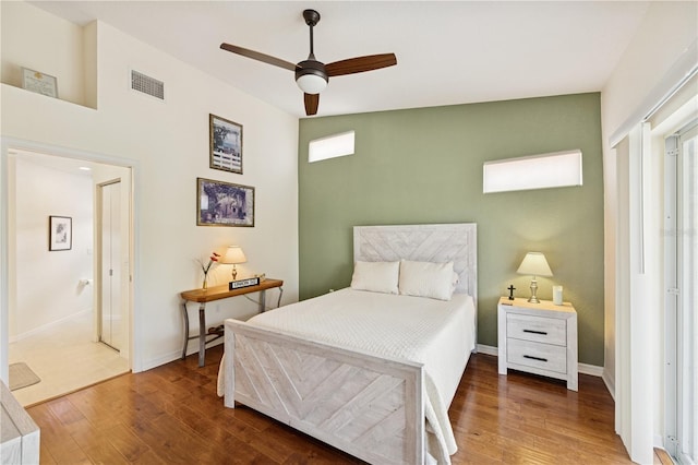 7532 Marsh Orchid Cir Unit 8-201, Bradenton, FL 34203 - bedroom featuring wood finished floors, baseboards, and a ceiling fan