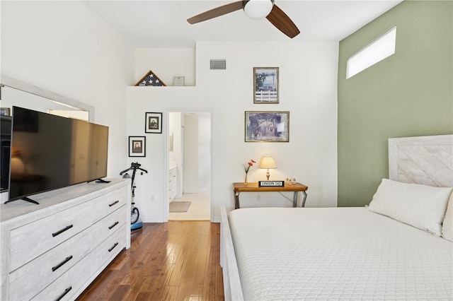7532 Marsh Orchid Cir Unit 8-201, Bradenton, FL 34203 - bedroom featuring dark wood-style floors, ensuite bath, a ceiling fan, and a towering ceiling