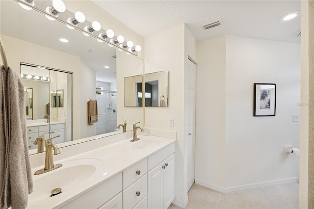 7532 Marsh Orchid Cir Unit 8-201, Bradenton, FL 34203 - full bathroom featuring double vanity, a shower stall, baseboards, and tile patterned floors