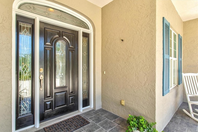 5373 Anthony Ln, Sarasota, FL 34233 - view of exterior entry featuring stucco siding