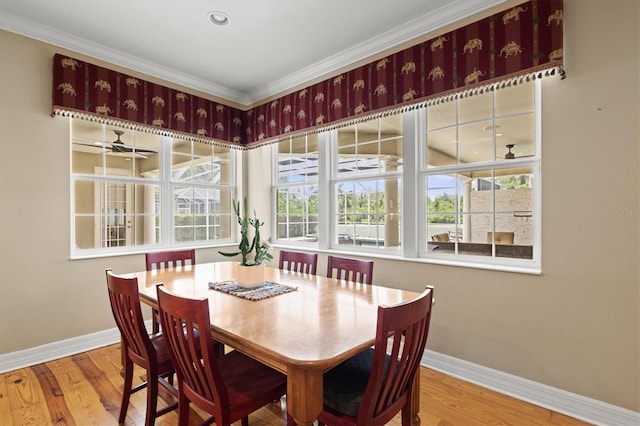 5373 Anthony Ln, Sarasota, FL 34233 - dining area featuring baseboards, wood finished floors, and crown molding