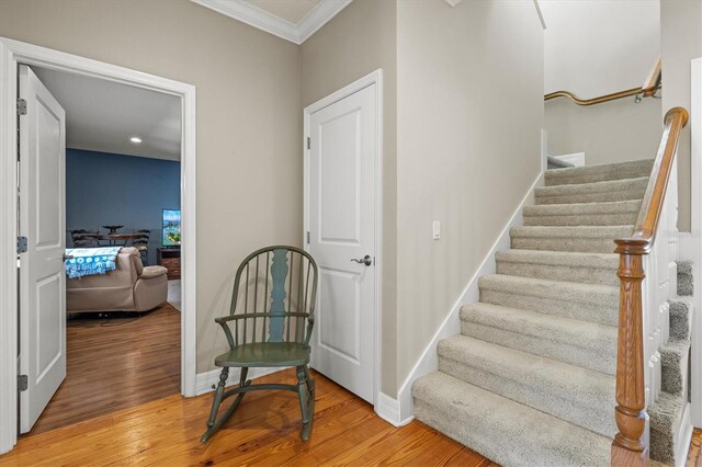 5373 Anthony Ln, Sarasota, FL 34233 - stairway featuring ornamental molding, wood finished floors, baseboards, and recessed lighting