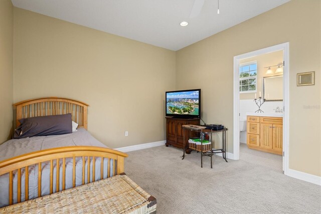 5373 Anthony Ln, Sarasota, FL 34233 - carpeted bedroom featuring baseboards, a sink, recessed lighting, and connected bathroom