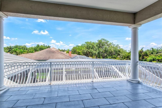 5373 Anthony Ln, Sarasota, FL 34233 - view of patio featuring a balcony and view of wooded area