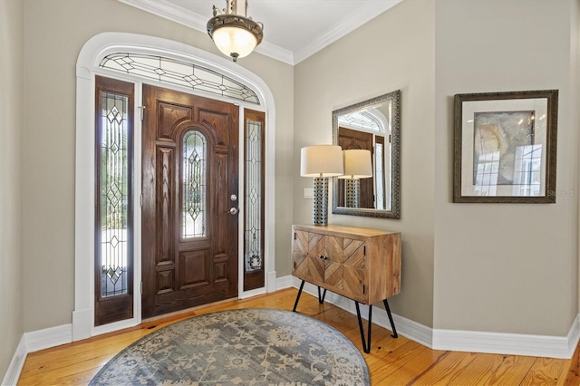 5373 Anthony Ln, Sarasota, FL 34233 - foyer entrance with baseboards, wood finished floors, and ornamental molding