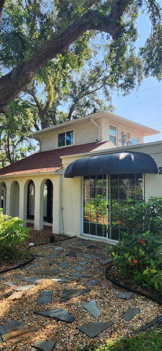219 24th St W, Bradenton, FL 34205 - view of front of property with stucco siding and a sunroom