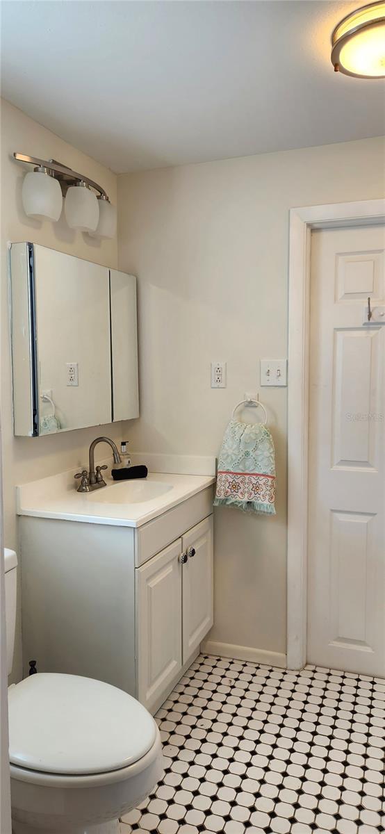 219 24th St W, Bradenton, FL 34205 - bathroom with vanity, toilet, and baseboards
