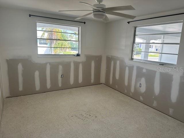669 Spanish Dr N Unit 21, Longboat Key, FL 34228 - empty room featuring healthy amount of natural light and a ceiling fan