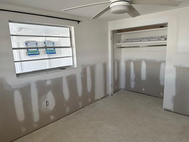 669 Spanish Dr N Unit 21, Longboat Key, FL 34228 - unfurnished bedroom with ceiling fan and a closet