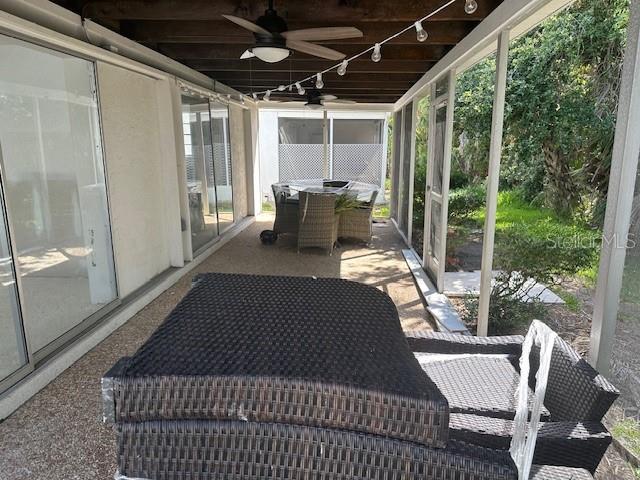 669 Spanish Dr N Unit 21, Longboat Key, FL 34228 - sunroom / solarium with a ceiling fan, outdoor dining area, and healthy amount of natural light