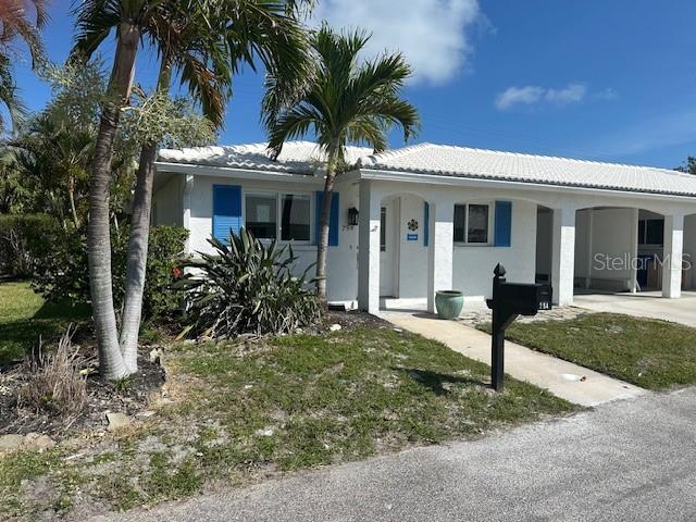 754 Spanish Dr S Unit 754, Longboat Key, FL 34228 - ranch-style home featuring a carport, driveway, stucco siding, and a tile roof