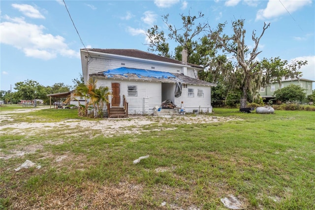 200 W Winifred St, Arcadia, FL 34266 - back of property with a chimney and a yard