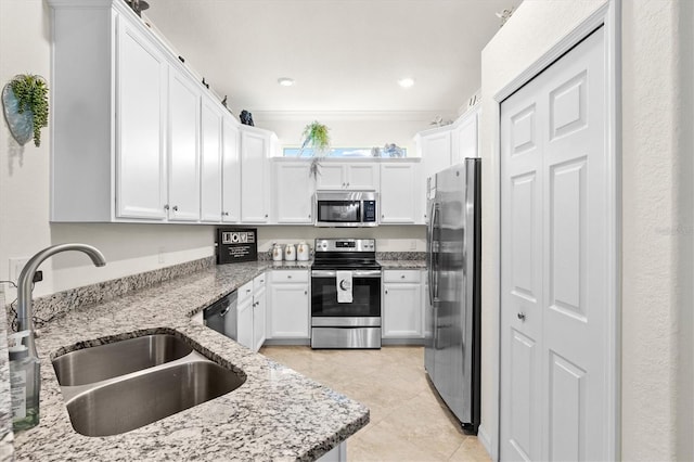 12230 Amica Loop, Venice, FL 34293 - kitchen featuring stainless steel appliances, a sink, white cabinets, and light stone countertops