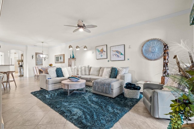 12230 Amica Loop, Venice, FL 34293 - living room featuring arched walkways, ceiling fan, light tile patterned floors, and ornamental molding