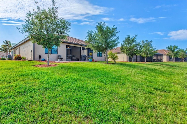 12230 Amica Loop, Venice, FL 34293 - view of green lawn with a sunroom