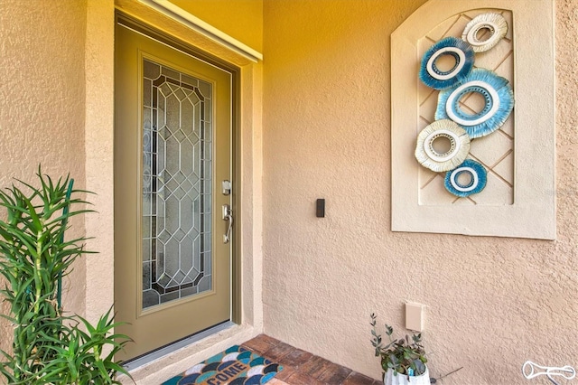 12230 Amica Loop, Venice, FL 34293 - doorway to property featuring stucco siding