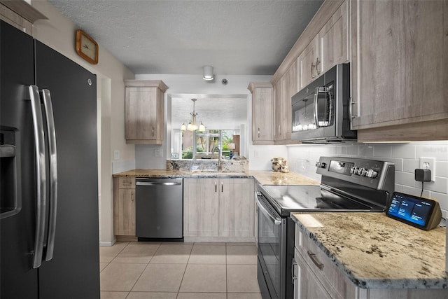 4530 Pinebrook Cir Unit 109, Bradenton, FL 34209 - kitchen featuring refrigerator with ice dispenser, stainless steel dishwasher, range with electric cooktop, black microwave, and a sink
