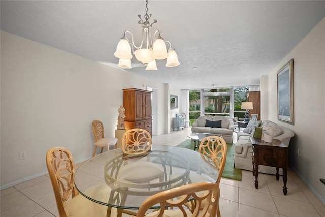 4530 Pinebrook Cir Unit 109, Bradenton, FL 34209 - dining area featuring light tile patterned floors, a chandelier, baseboards, and a textured ceiling