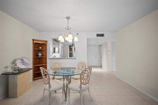 4530 Pinebrook Cir Unit 109, Bradenton, FL 34209 - dining area with a chandelier, light tile patterned floors, and baseboards