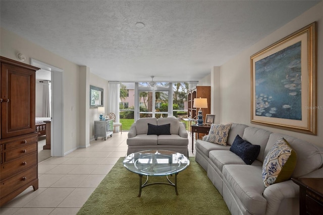 4530 Pinebrook Cir Unit 109, Bradenton, FL 34209 - living area with ceiling fan, light tile patterned flooring, a textured ceiling, and baseboards