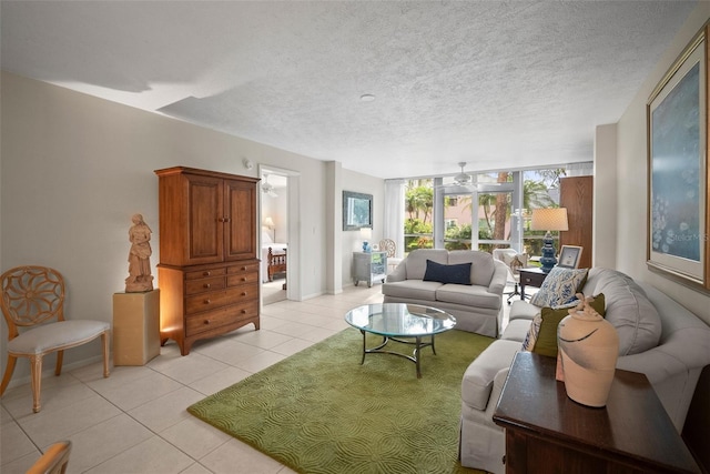 4530 Pinebrook Cir Unit 109, Bradenton, FL 34209 - living area with light tile patterned floors, a textured ceiling, and baseboards