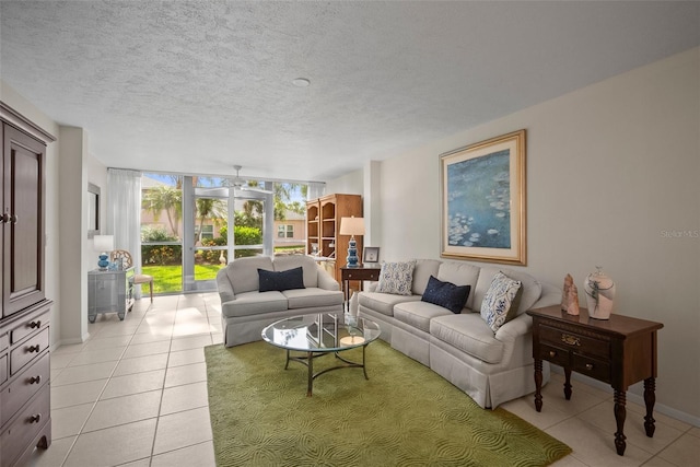 4530 Pinebrook Cir Unit 109, Bradenton, FL 34209 - living area with light tile patterned flooring, a textured ceiling, and baseboards